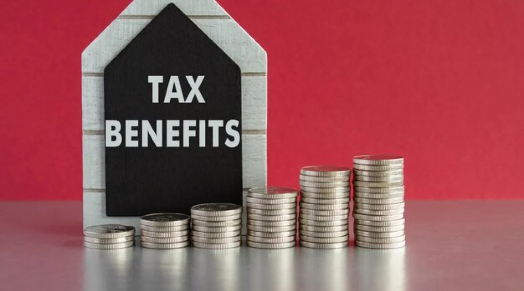 Business owner reviewing tax documents and calculating deductions for LLC